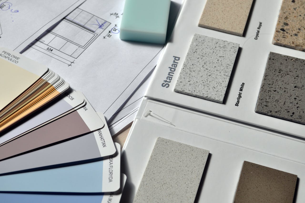 about-us Color palette and material samples for interior renovation projects on a blueprint.